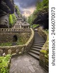 The old gas power plant built from massive stone in a rocky gorge. Pure nature in the area of ​​Hřensko, Bohemian Switzerland National Park, Ústecký kraj, Czech Republic.