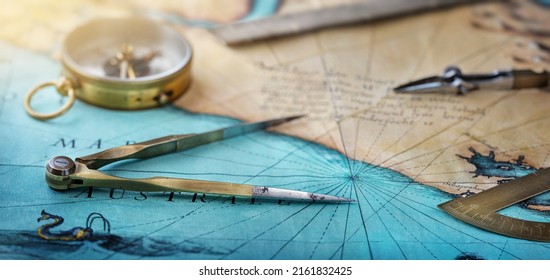 An old geographic map with navigational tools: compass, divider, ruler, protractor. View of the workplace of ship's captain. Travel, geography, navigation, tourism and exploration concept background. - Shutterstock ID 2161832425
