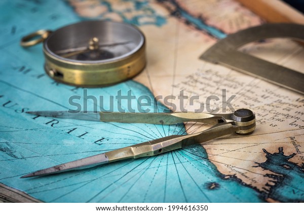 An old geographic map with navigational tools:
compass, divider, protractor. View of the workplace of ship's
captain. Travel, geography, navigation, tourism, history and
exploration concept
background