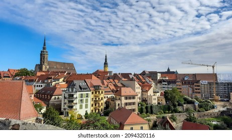 Old German City Skyline With Construction Crane And Churches. Old And Modern Houses In A German Town In East Germany.