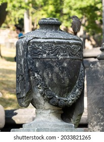 Old German Graveyard Sculpture With A Bird Flying Around.