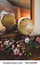 The old globe is at the mirror.