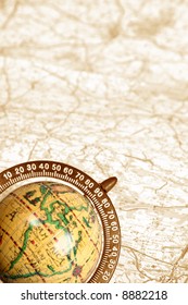 old globe on background of map