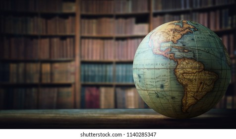 Old globe on bookshelf background. Selective focus. Retro style. Science, education, travel, vintage background. History and geography team.