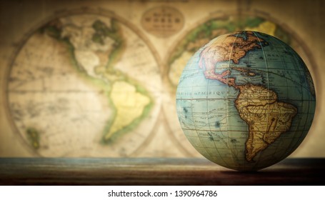 Old globe on vintage map background. Selective focus. Travel, stories and education background. 
