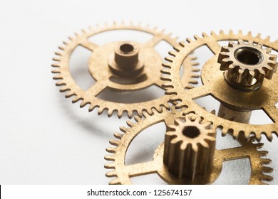 old gold clock gear on white background