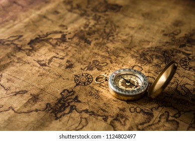 Old gold compass on ancient map background ,vintage tone with copy space for text. - Shutterstock ID 1124802497