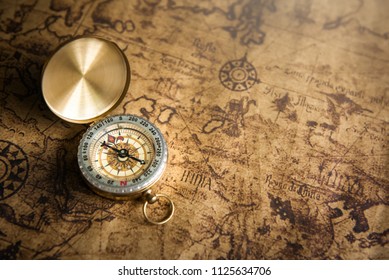 Old gold compass on ancient map background ,vintage tone with copy space for text. - Shutterstock ID 1125634706