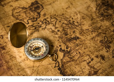 Old gold compass on ancient map background ,vintage tone with copy space for text. - Shutterstock ID 1145470964