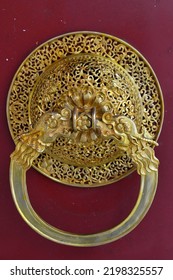 Old Golden Metal Door Handle Knocker On A Red Chinese Monastery Door