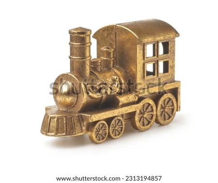Old golden toy steam train locomotive isolated on white