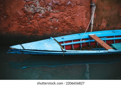 An Old Gondola, A Traditional Narrow And Long Venetian Rowing Boat.