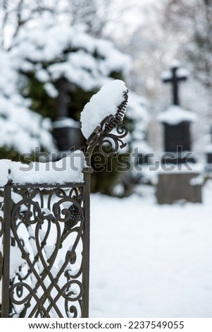 old grave yard in snow, haunted and decaying