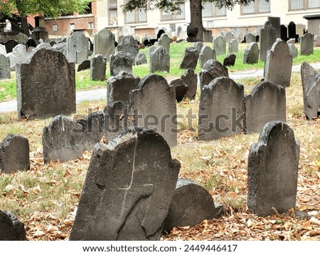 Old graves with some falling over in graveyard in Boston Massachusetts