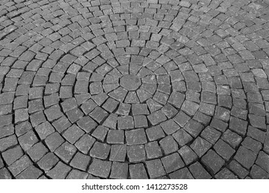 Old Gray Pavement Of Cubic Cobblestones Laid In Concentric Circles