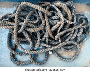 Old Gray Rope On A Sandy Floor