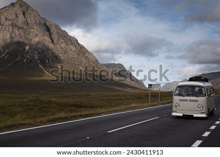 An old gray and white van travels between mountains on the A82 road in Glencoe, Scottish Highlands Stock photo © 