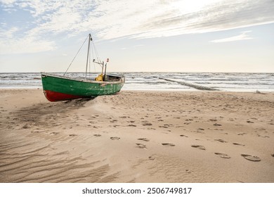 Old green abandoned wooden boat on a shores of Baltic sea - Powered by Shutterstock