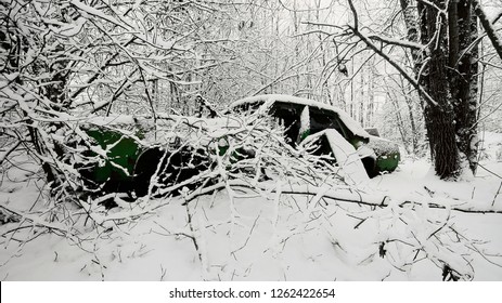 Old Green, American Made Car Abandoned In The Snowy Forest At Southern Finland. 