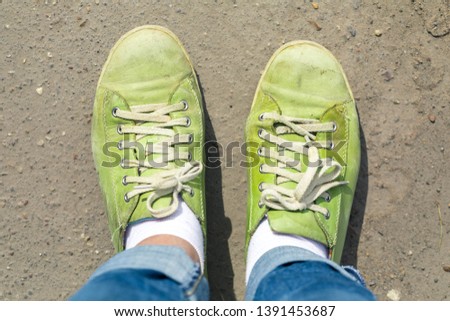 Similar – Person standing on a path with a green leaf nearby