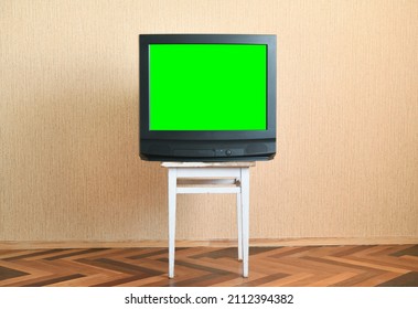 Old Green Screen TV On An Old Chair, Old House Design In 1980s And 1990s Style.