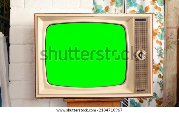 Old green screen TV\
in a rustic interior.