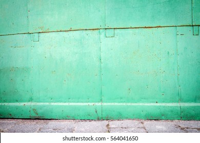 Old green weathered metal tin street wall