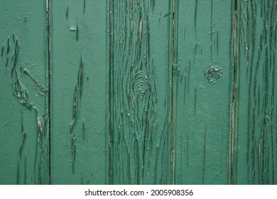 Old green wooden wall with cracked paint, background texture. High quality photo