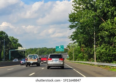 Old Greenwich, CT, USA-August 2020; View down Southbound lane highway I-95 with cars approaching exit sign of Riverside and Old Greenwich