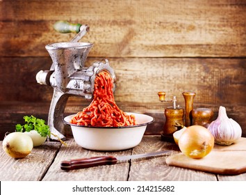 old grinder with minced meat on wooden table