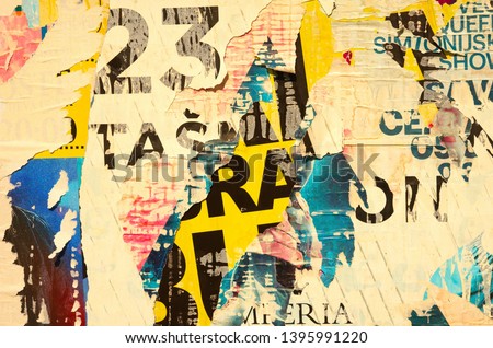 Old grunge ripped torn vintage collage colorful street posters creased crumpled paper surface backdrop