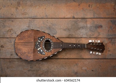 Old grunge vintage mandolin on wooden wall