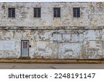 Old, grungy industrial building in a rust belt community. Old buildings in former auto factory towns are becoming run down and blighted eye sores.