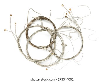 Old Guitar Strings, Isolated On White, Old Guitar Strings, Coiled And Bundled. 