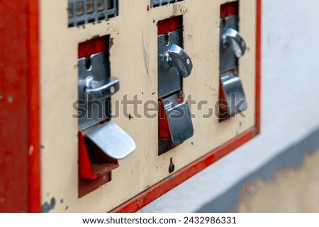 old gumball machine in selective focus in the city