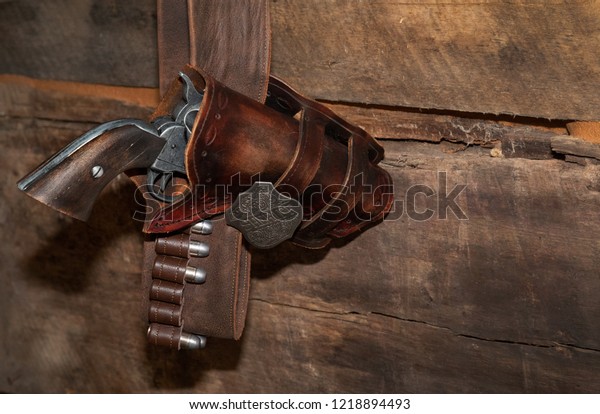 old gun with sheriff \
badge