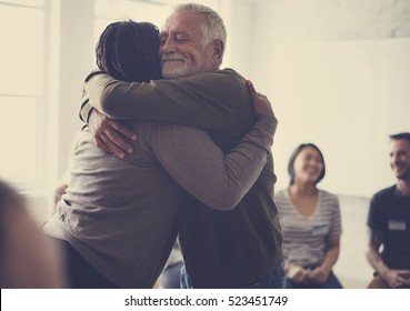 Old guy consoling a woman with a hug - Shutterstock ID 523451749