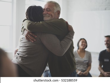 Old guy consoling a woman with a hug