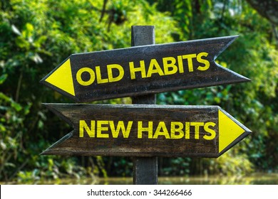 Old Habits - New Habits signpost with forest background - Shutterstock ID 344266466