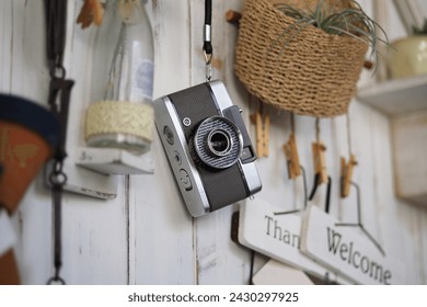 An old half-frame camera hanging on the wall.