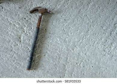 Old hammer on the cement floor.