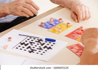 Old Hands Of Seniors Playing Bingo In The Retirement Home