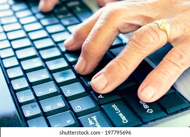 Old Hands Typing On Computer Keyboard