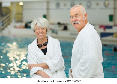 Old Happy Couple In Swimming Pool