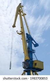 Old Harbor Big Blue And Yellow Crane Close In Sky
