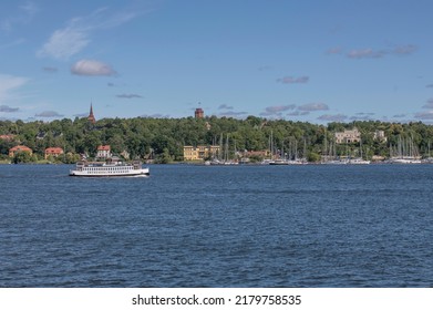 Old Harbor Ferry Passing The Island Djurgården A Sunny Summer Day In Stockholm, Sweden 2022-07-17