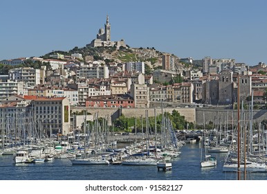 The old harbor "Vieux Port" and the church "Notre Dame de la Garde" of "Marseille" in France