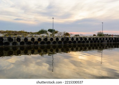 An Old Harbour Wall With Hanging Tyres.