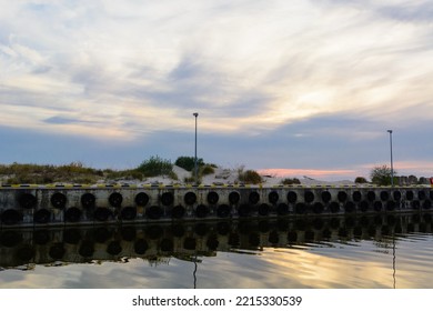 An Old Harbour Wall With Hanging Tyres.