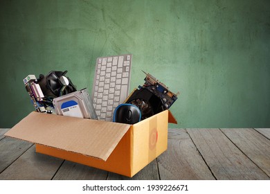Old harddisk dive and motherboards and used keyboard with mouse old computer hardware accessories in paper boxes on wooden floor, Obsolete equipment is electronic waste Reuse and Recycle concept. - Shutterstock ID 1939226671